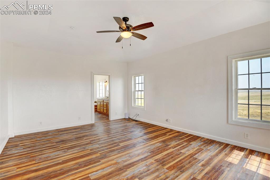 Image 16 of 45: Spare room featuring a healthy amount of sunlight, hardwood / wood-style fl