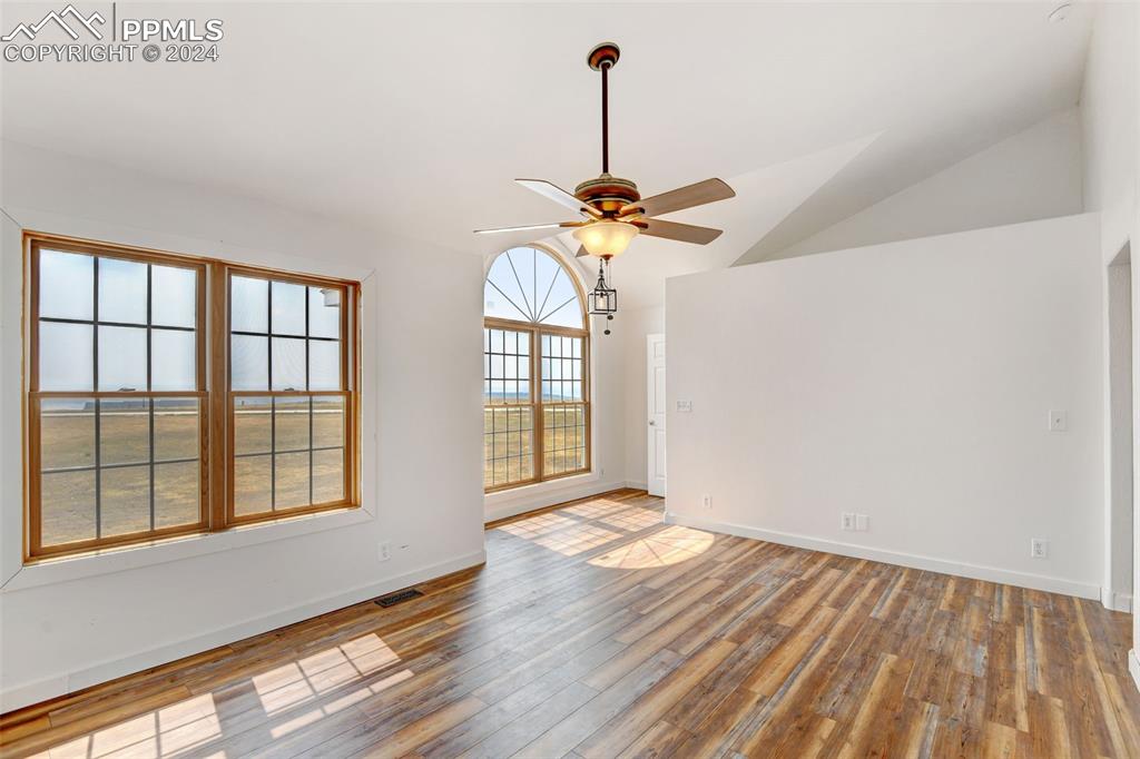 Image 22 of 45: Spare room featuring vaulted ceiling, hardwood / wood-style floors, and cei