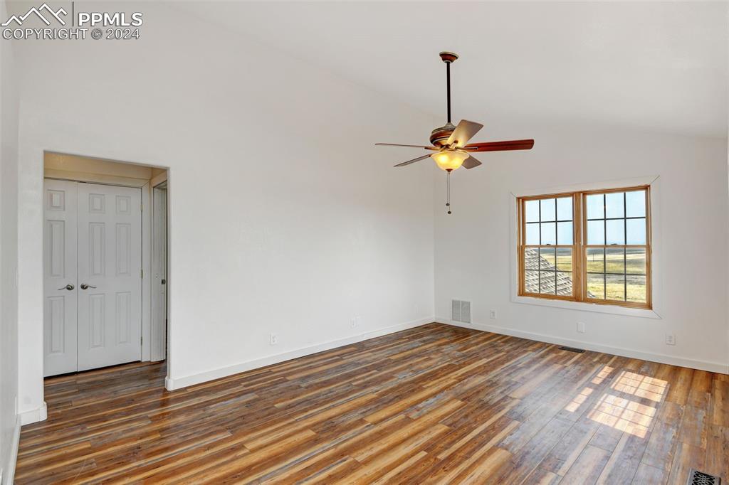 Image 23 of 45: Empty room featuring hardwood / wood-style flooring, high vaulted ceiling,