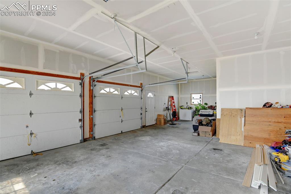 Image 32 of 45: 2 car oversized attached garage. drywall