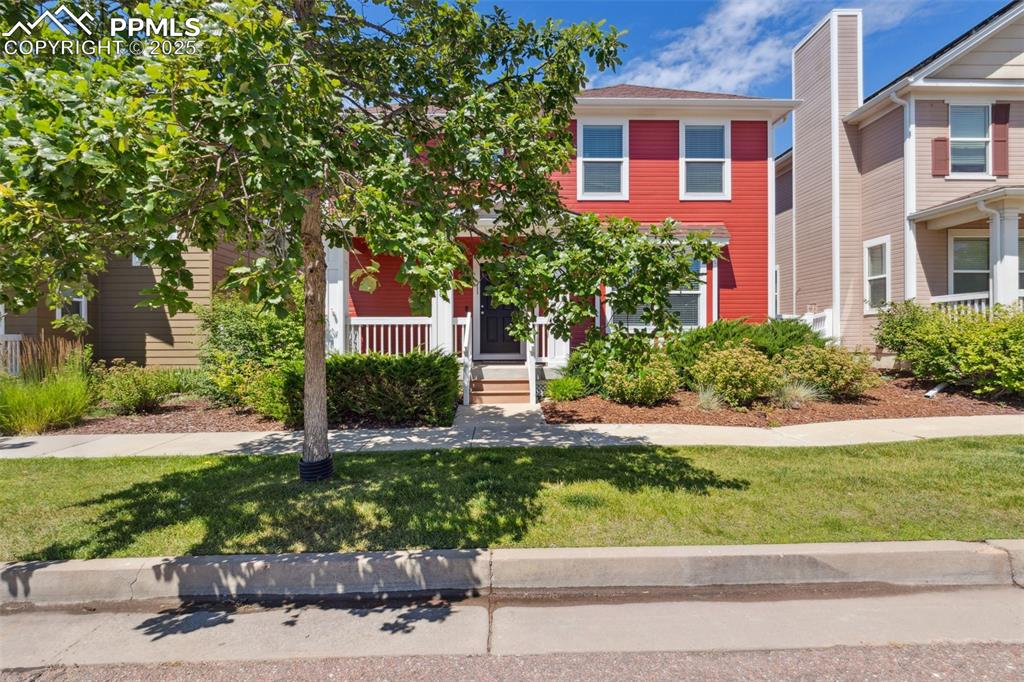Image 2 of 30: View of front of house with a front lawn and a porch