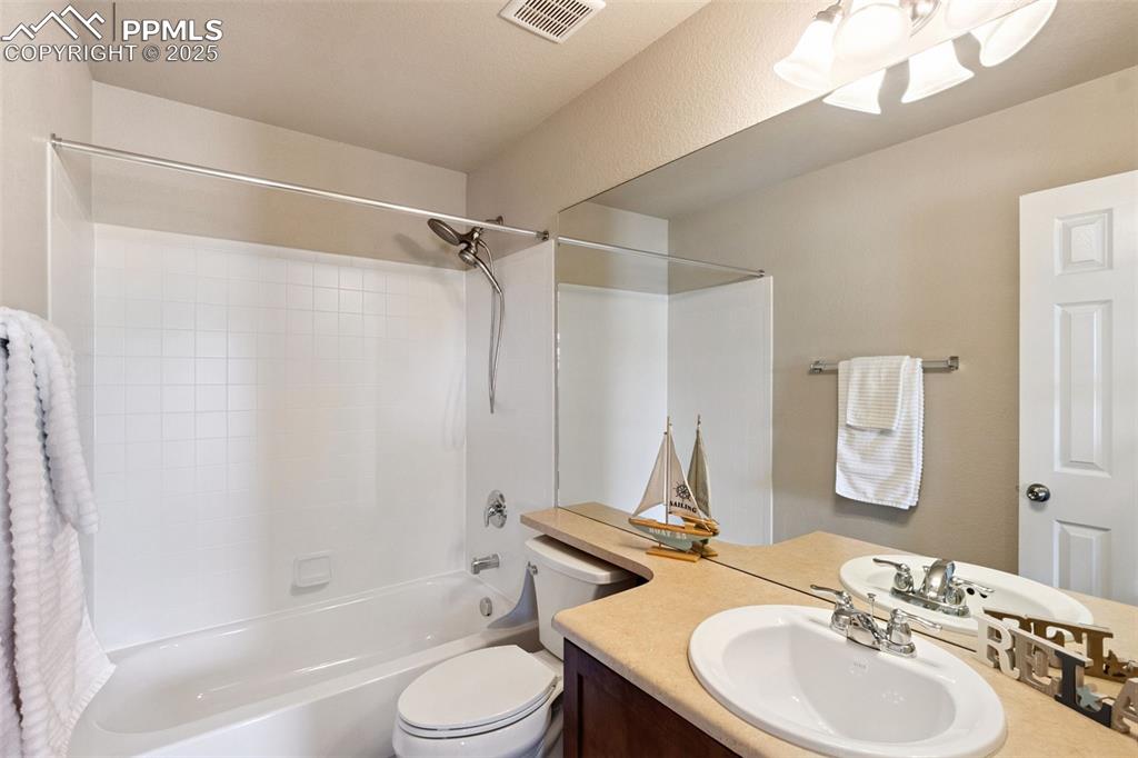 Image 26 of 30: Bathroom with vanity and shower / bathtub combination