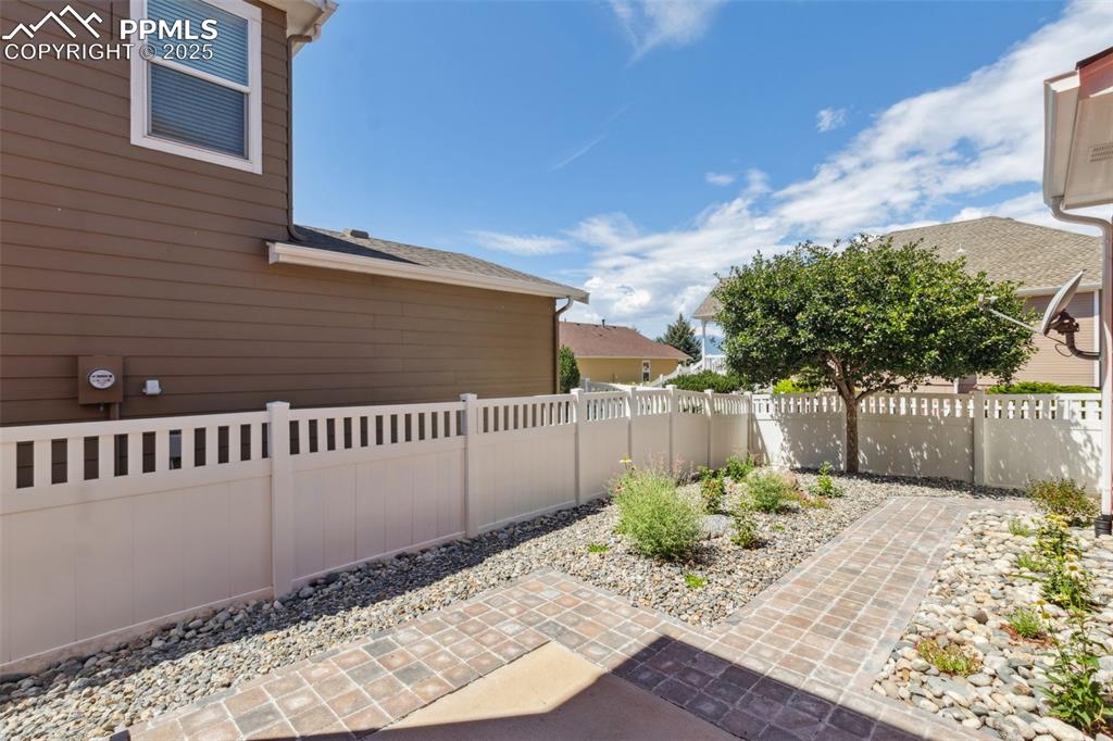 Image 27 of 30: Fenced backyard featuring a patio area
