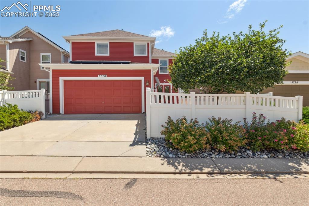 Image 30 of 30: View of front of home with driveway and a garage