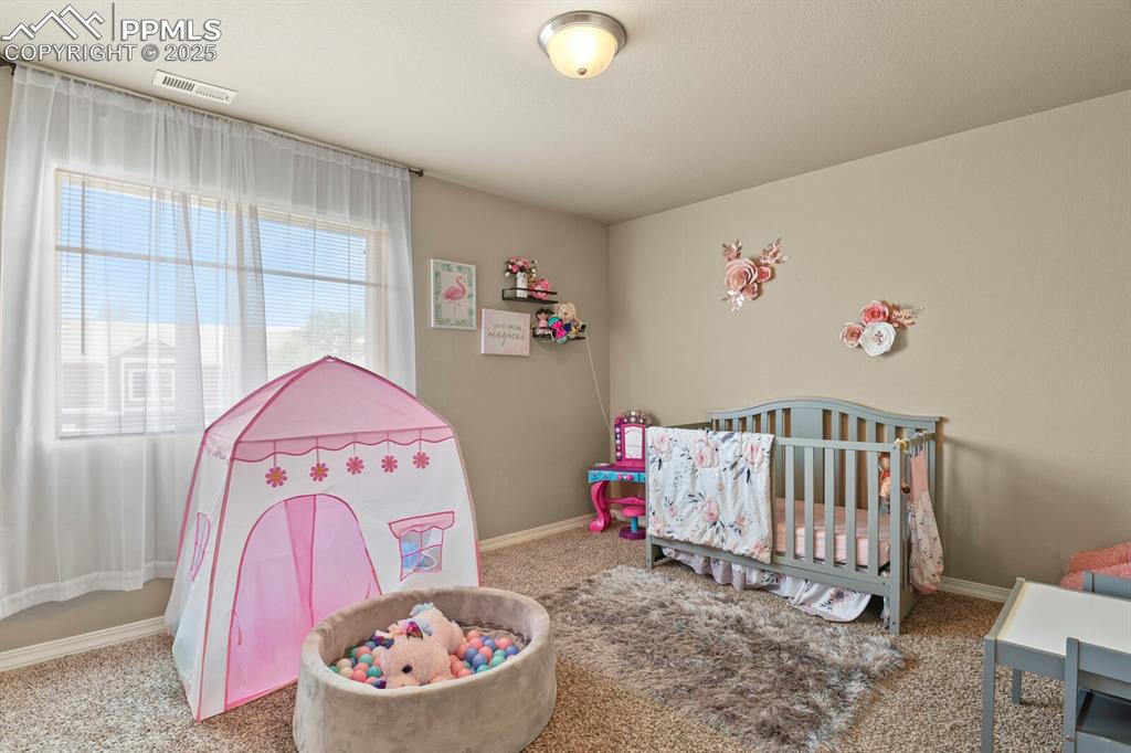 Image 23 of 30: Carpeted bedroom with baseboards