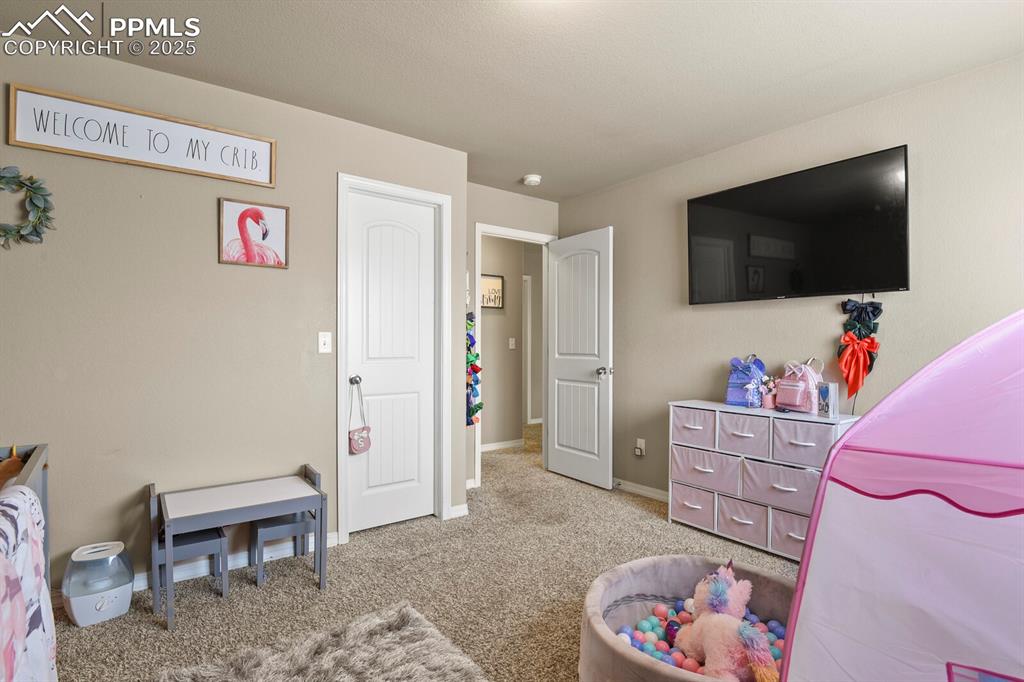 Image 24 of 30: Bedroom with carpet flooring and baseboards