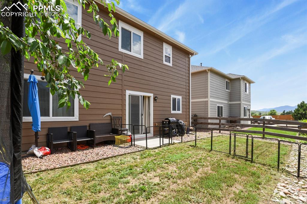 Image 30 of 30: Rear view of property featuring a patio, a gate, and a mountain view