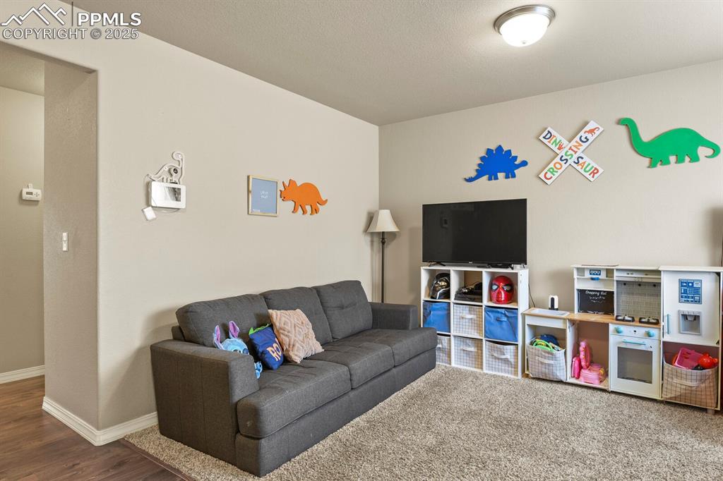 Image 4 of 30: Living room featuring baseboards and wood finished floors