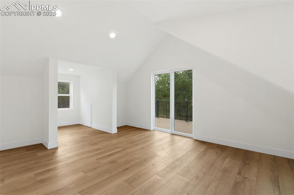 Image 19 of 43: Master bedroom with private deck and attached bath.