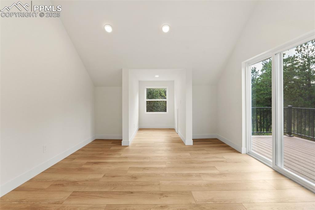 Image 20 of 43: Mater bedroom featuring lofted ceiling, recessed lighting, and light wood-s