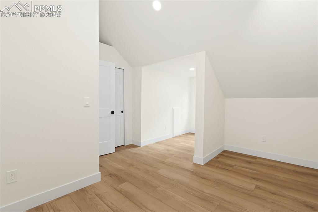 Image 27 of 43: Bonus room with vaulted ceiling, recessed lighting, and light wood-type flo