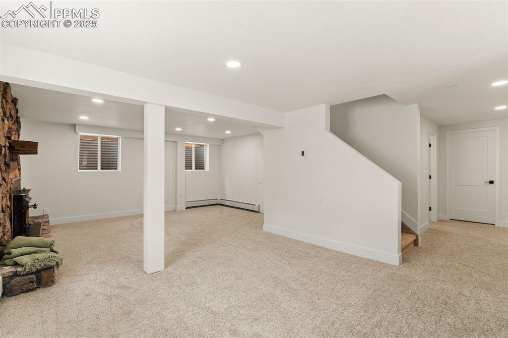 Image 30 of 43: Finished below grade area with recessed lighting, light colored carpet, sta