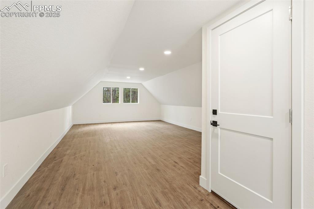 Image 39 of 43: Bonus room featuring light wood-style floors, vaulted ceiling, and recessed