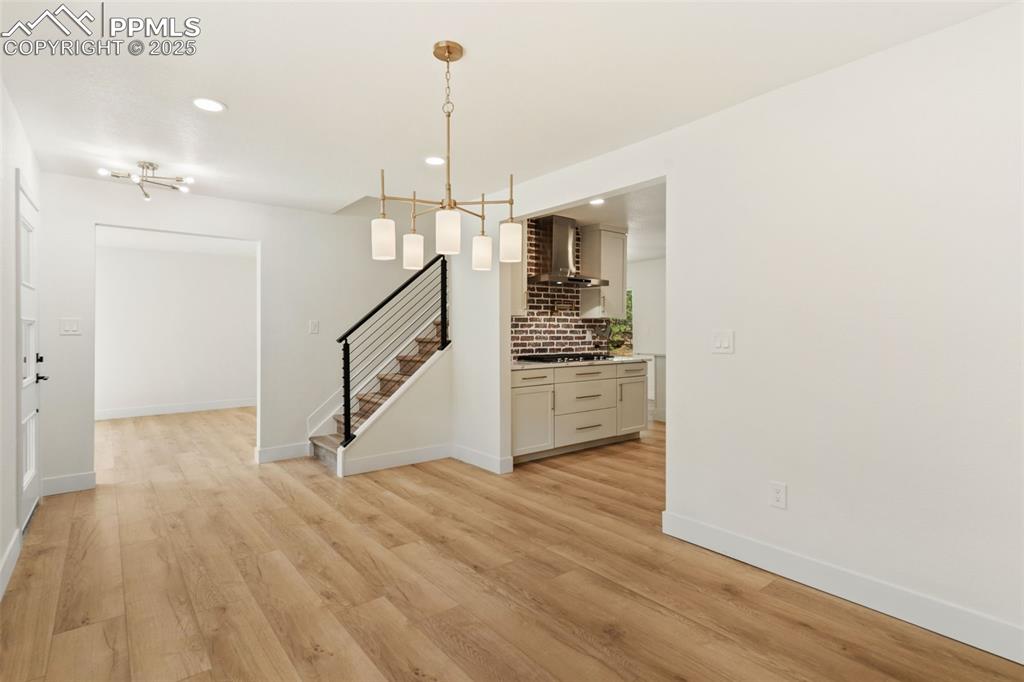 Image 7 of 43: Unfurnished dining area with light wood-style floors, recessed lighting, a 