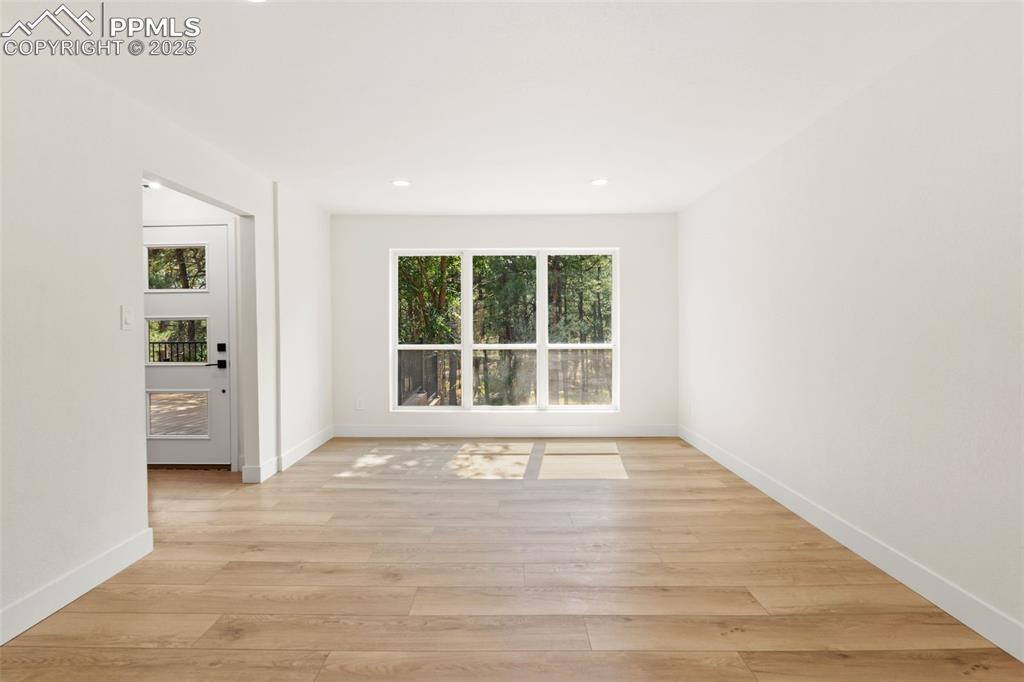 Image 8 of 43: Unfurnished room with light wood-type flooring and recessed lighting