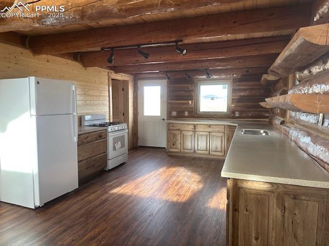Image 21 of 28: Kitchen with dark wood finished floors, beamed ceiling, wood ceiling, rusti