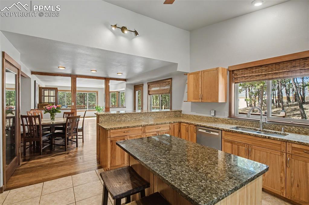 Image 20 of 50: Kitchen island, including a breakfast bar area.
