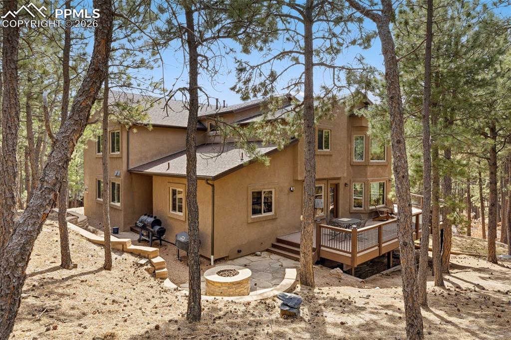Image 4 of 50: Back of property showing gas firepit
