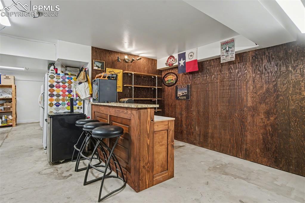 Image 45 of 50: Dry bar in garage