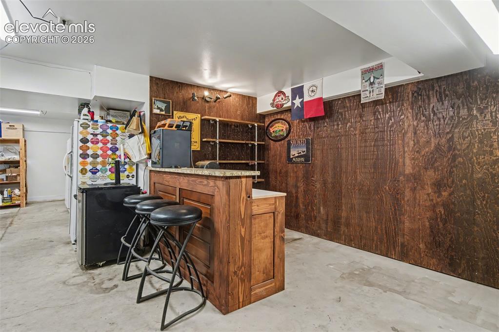 Image 46 of 50: Dry bar in garage