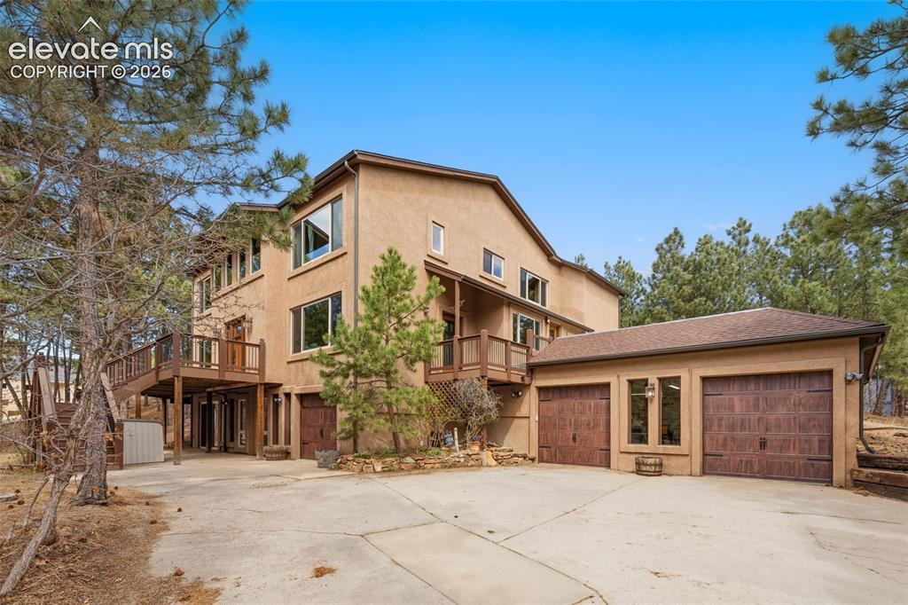 Image 5 of 50: Front of property showing 3 car garage