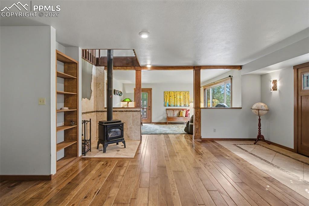 Image 9 of 50: View of main level entry facing wood burning fireplace and living room