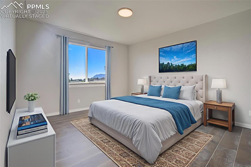 Image 14 of 44: Bedroom featuring wood finished floors, virtually staged