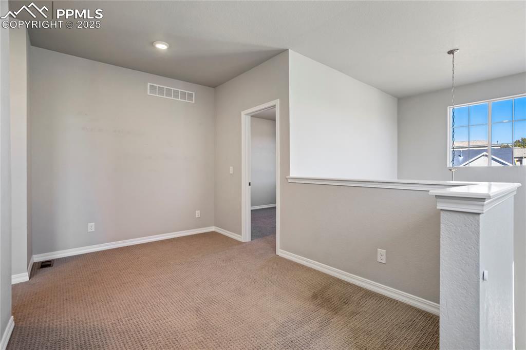 Image 19 of 44: Empty room featuring carpet and baseboards