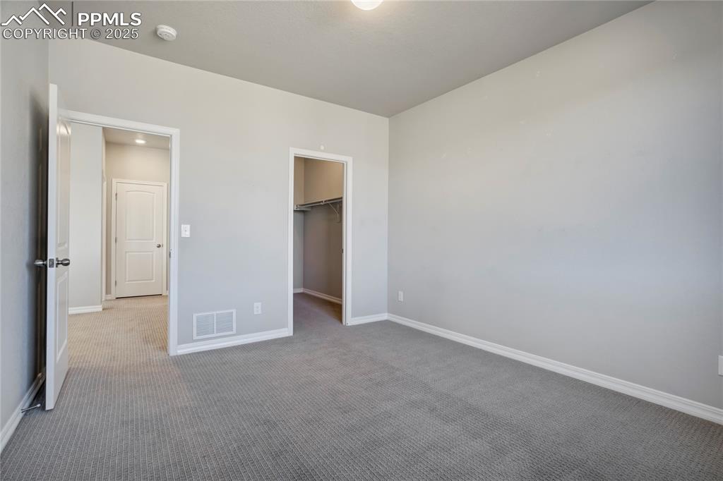 Image 21 of 44: Unfurnished bedroom with carpet floors and a spacious closet