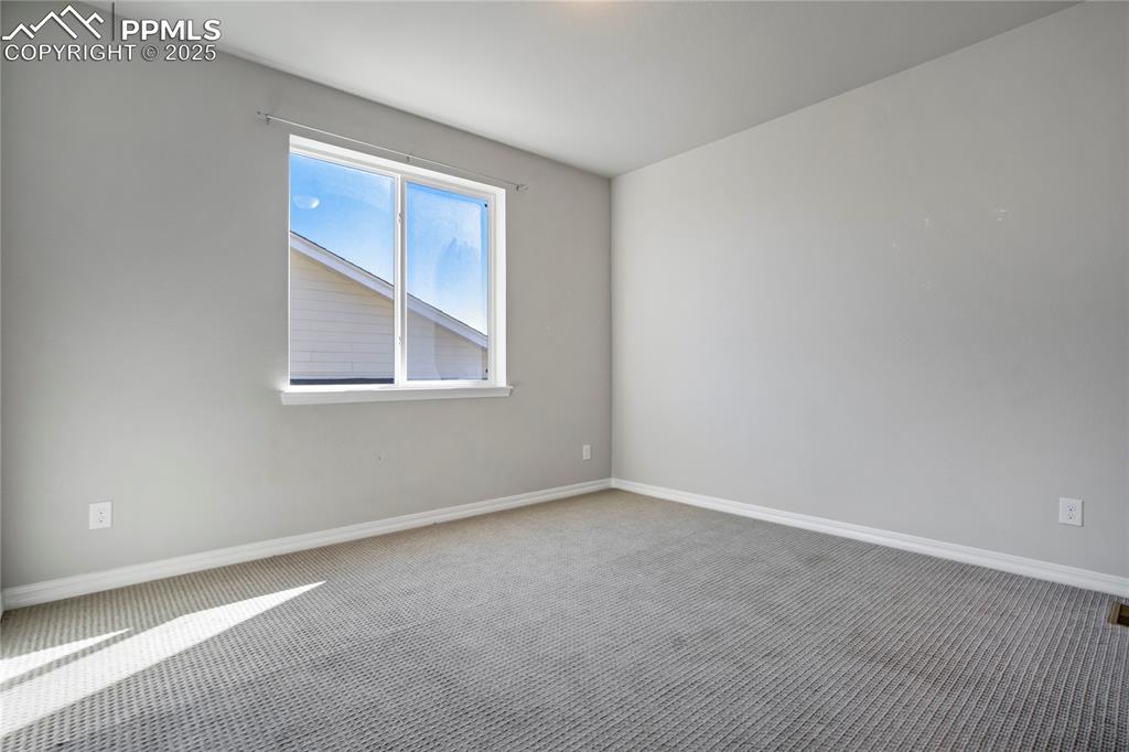 Image 23 of 44: Carpeted spare room with baseboards