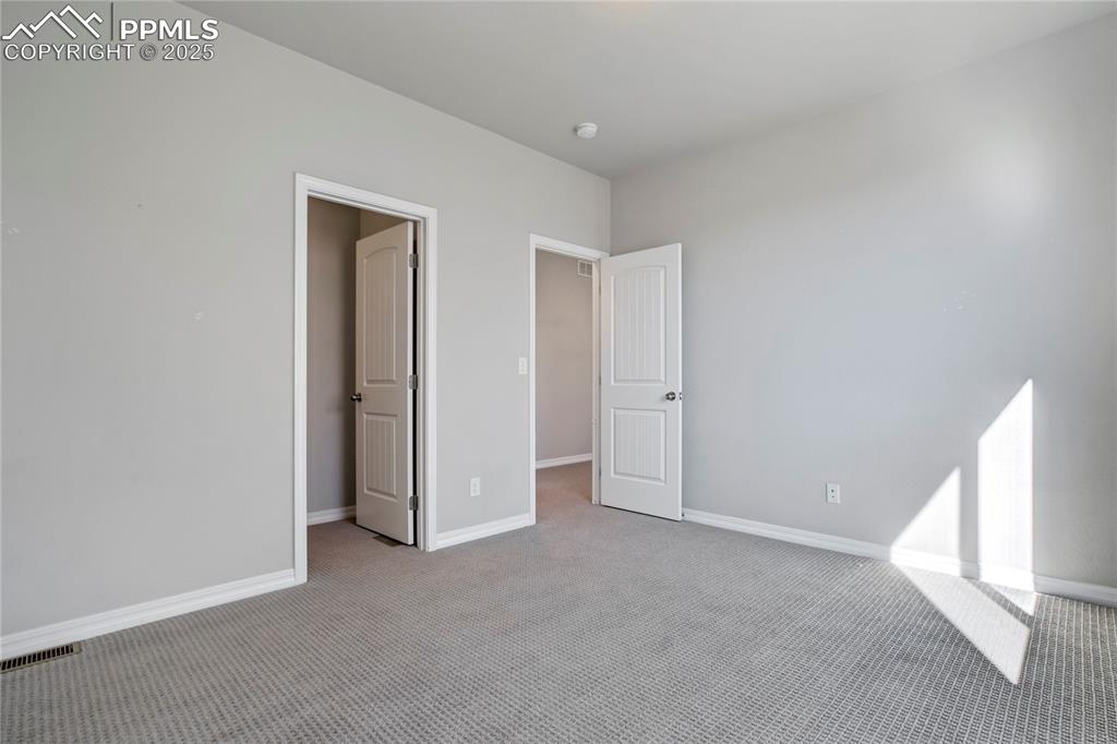 Image 24 of 44: Unfurnished bedroom with carpet and baseboards