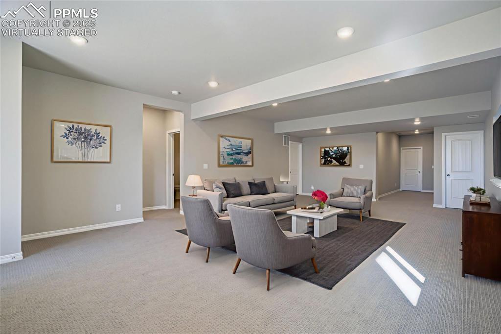 Image 28 of 44: Living room featuring light carpet and recessed lighting, virtually staged