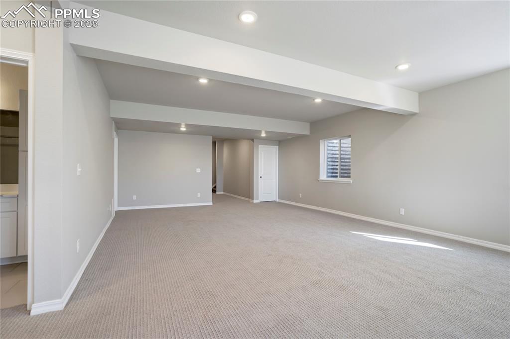 Image 29 of 44: Basement featuring light colored carpet and recessed lighting