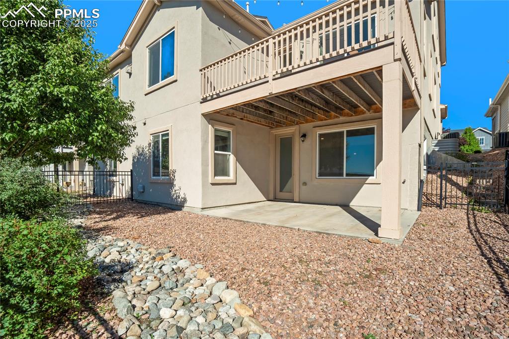 Image 34 of 44: Back of property with a patio area, stucco siding, and a fenced backyard
