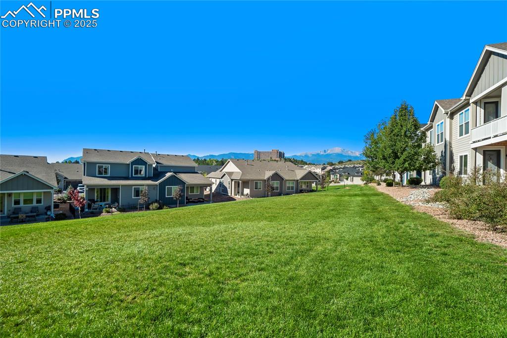 Image 35 of 44: View of grassy yard featuring a residential view and a mountain view