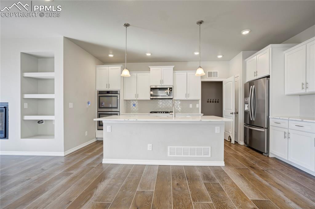 Image 4 of 44: Kitchen with built in features, appliances with stainless steel finishes, w