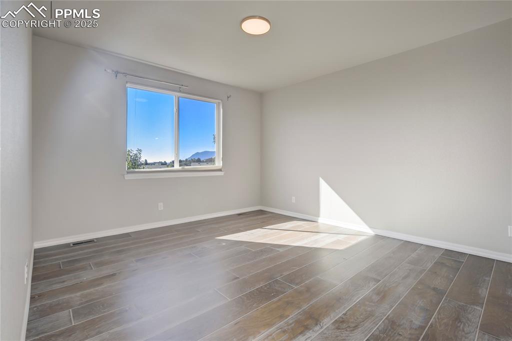 Image 40 of 44: Spare room featuring wood finished floors