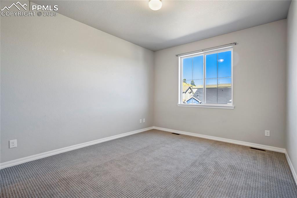 Image 41 of 44: Unfurnished room with carpet floors and baseboards