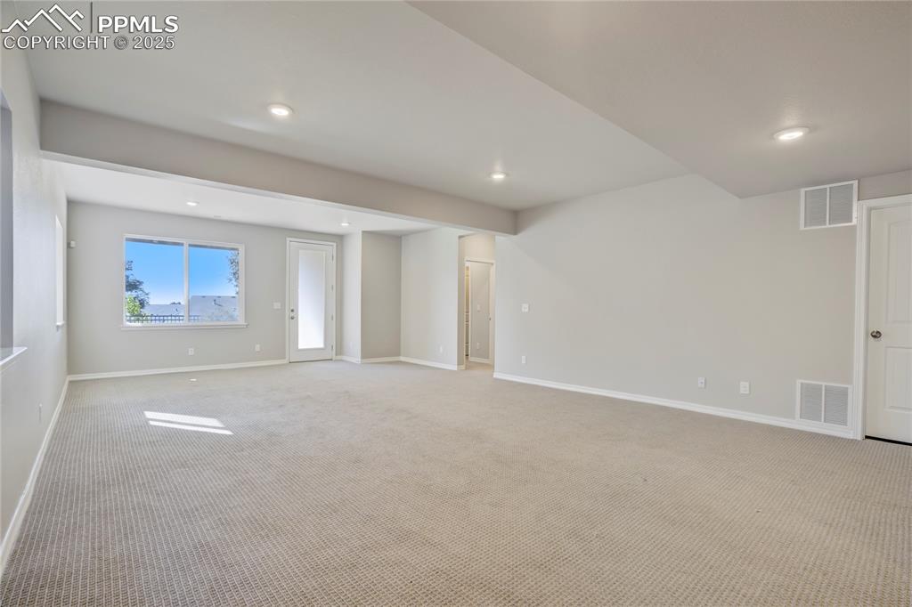 Image 42 of 44: Unfurnished living room with carpet and recessed lighting