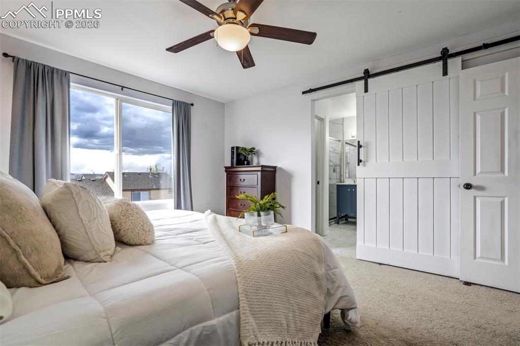 Image 26 of 42: Barn door leads to the completely redone bathroom. 