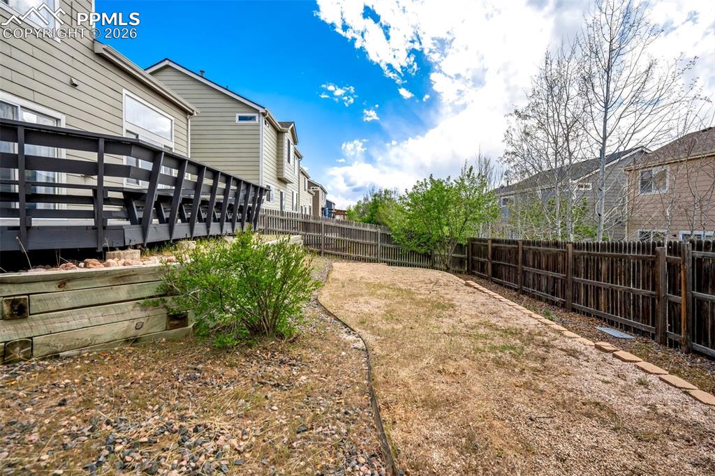 Image 40 of 42: Fenced backyard. 