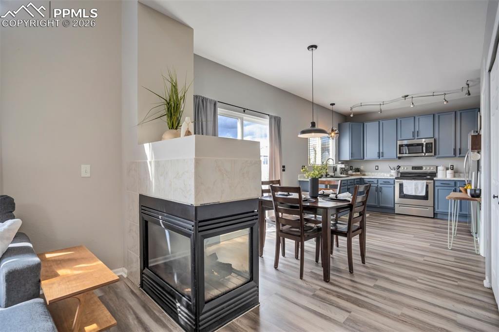 Image 7 of 42: Fireplace that can be enjoyed from the living room and dining area. 