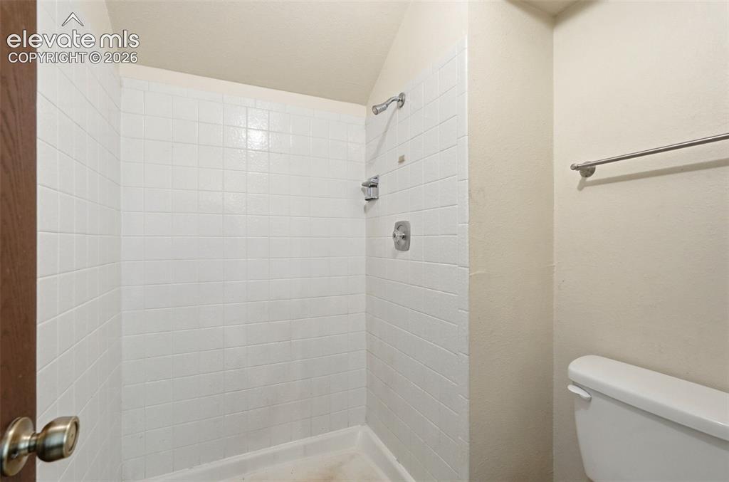 Image 25 of 50: Shower stall with white square tiling, brushed nickel shower fixtures, and 