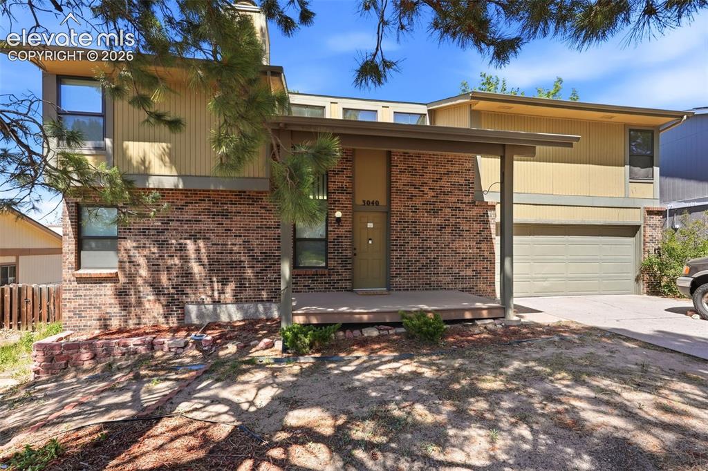 Image 3 of 50: Split-level residence featuring a brick and siding exterior