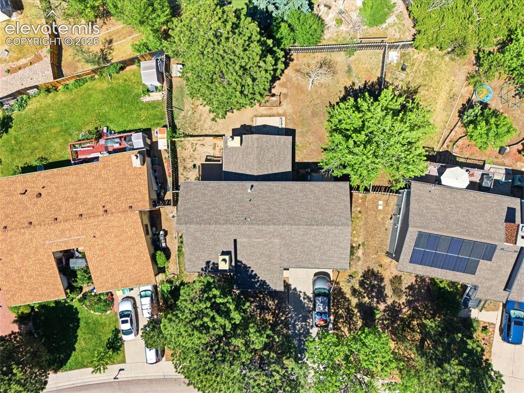 Image 48 of 50: Aerial perspective of the property, featuring a gray shingle roof, establis