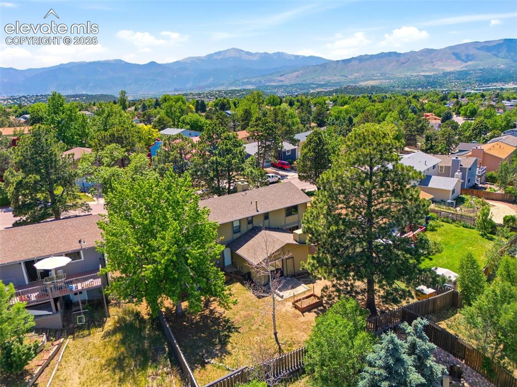 Image 49 of 50: Expansive residential property featuring a large backyard, mature trees, an