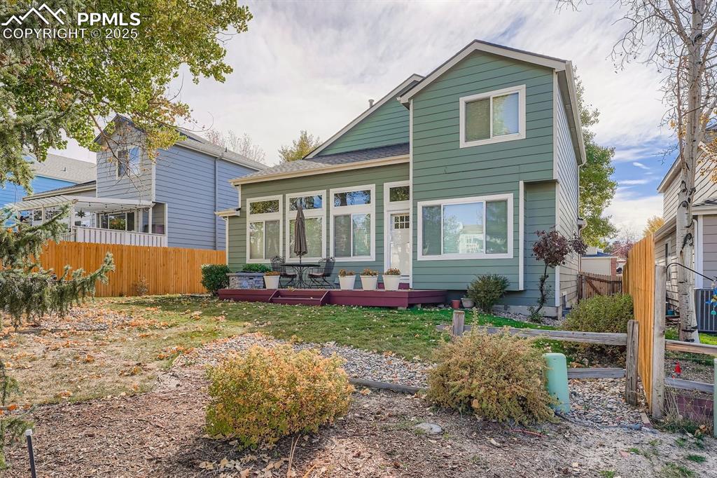 Image 26 of 32: Rear view of house with a deck