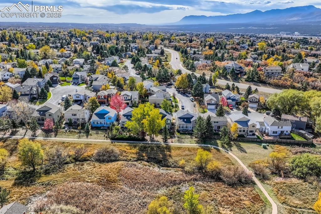 Image 31 of 32: Aerial perspective of suburban area featuring a mountainous background