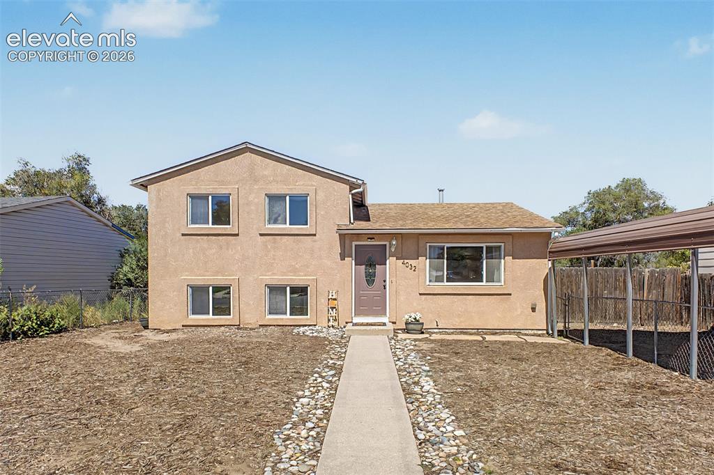 Caption: Stucco exterior fenced yard and low maintenance landscaping. 