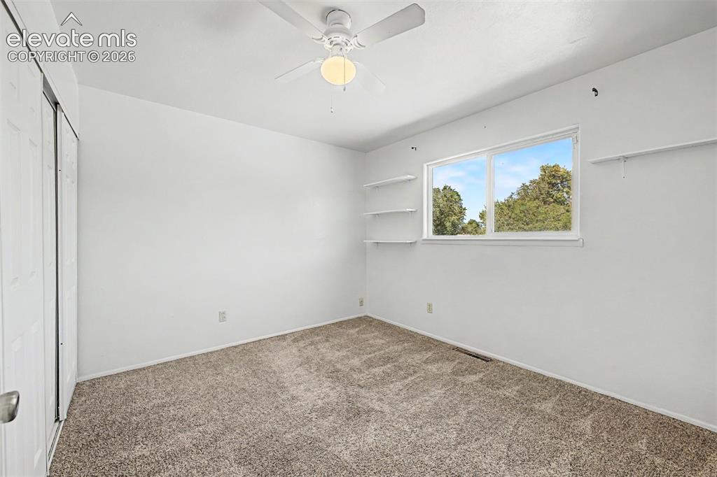 Image 11 of 37: Guest bedroom offers neutral carpet, natural lighting and a mountain view